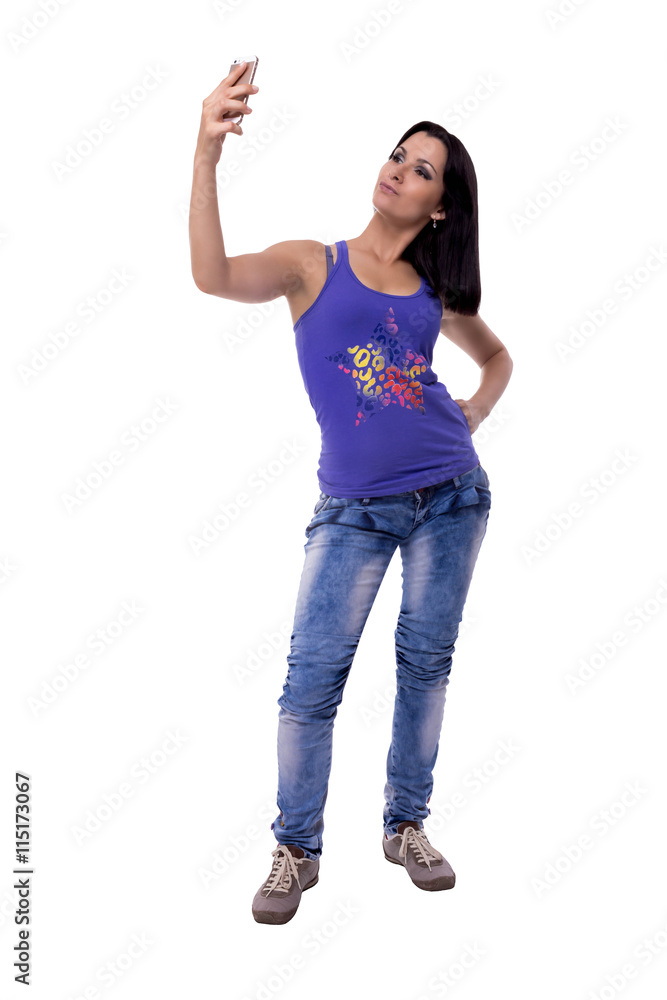 very beautiful young woman is photographed doing selfie on a mobile phone isolated on white background very beautiful young woman is photographed doing selfie on a mobile phone isolated on white background
