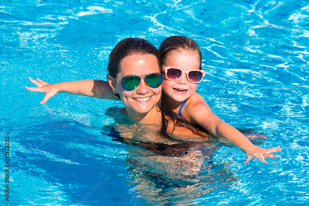 happy little girl and mother in pool happy little girl and mother in pool