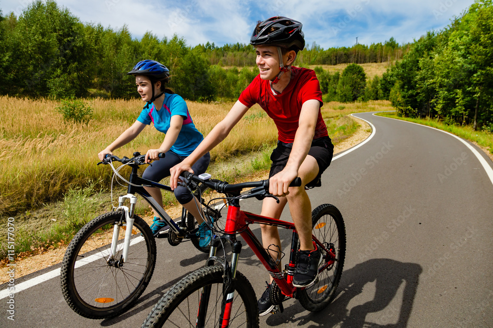 Healthy lifestyle - teenage girl and boy cycling Healthy lifestyle - teenage girl and boy cycling