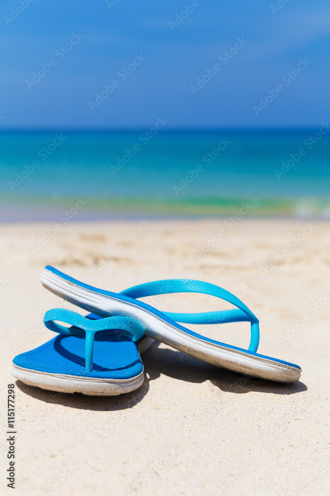 Blue slippers on the beach