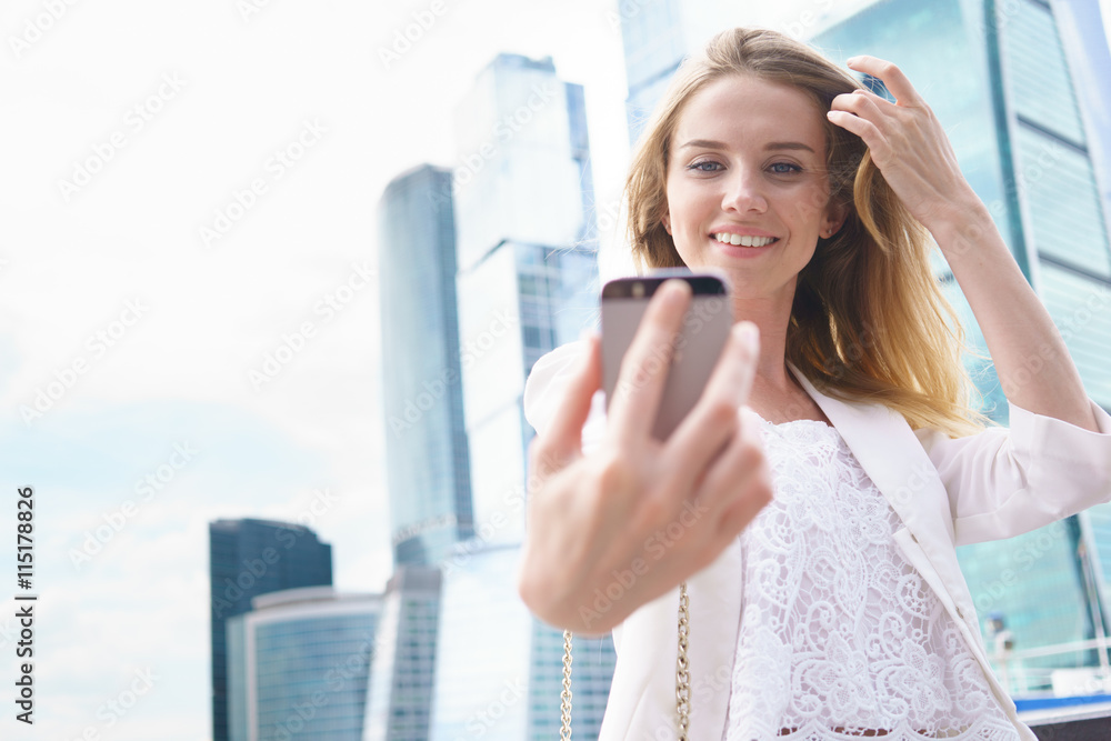 Fototapeta premium Woman making selfie by her smart phone