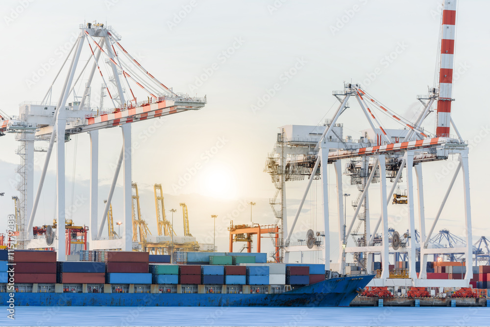 Container Cargo ship with ports crane bridge in harbor for logistic import export background and transport industry.