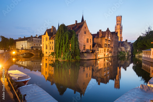 Bruges, Belgium. Image with Rozenhoedkaai in Brugge, Dijver river canal and Belfort, Belfry, tower in twilight. photo