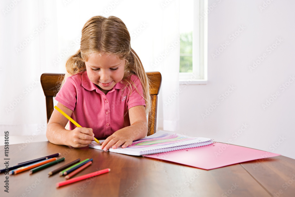 Education: Cute Girl Drawing Rainbow At Table With Colored Penci Education: Cute Girl Drawing Rainbow At Table With Colored Penci