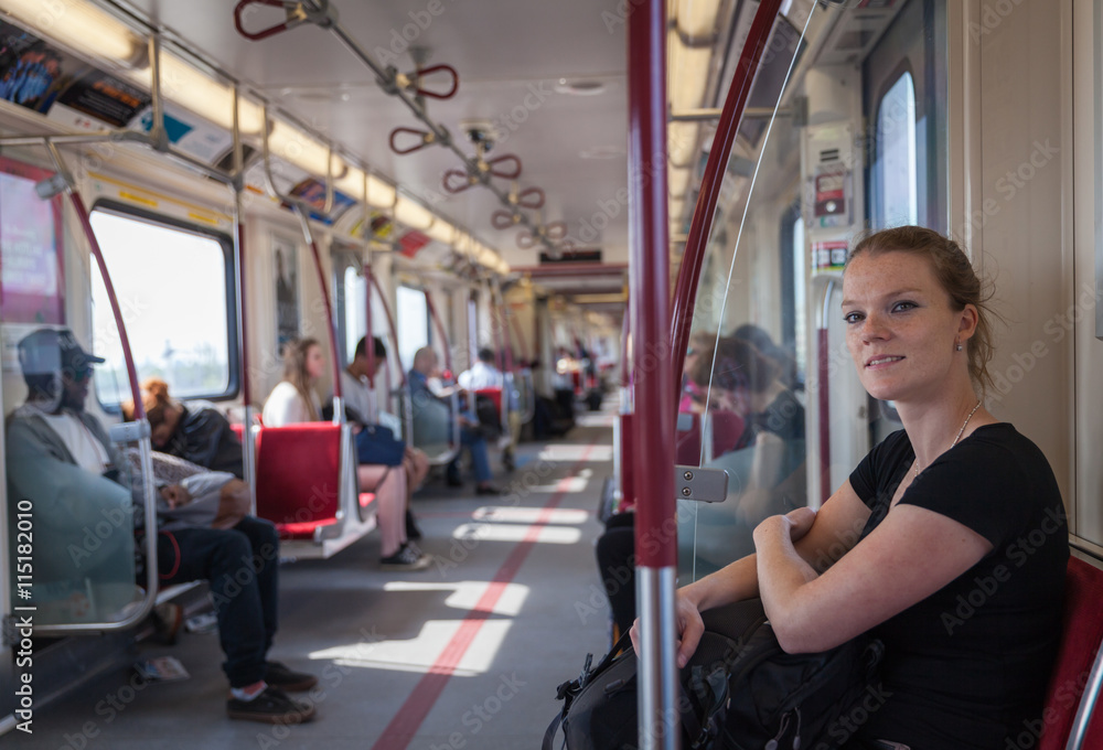 Woman travels overground metro in the afternoon in Canada Woman travels overground metro in the afternoon in Canada