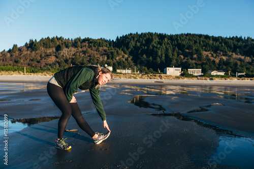 Fototapeta Naklejka Na Ścianę i Meble -  Female Runner on the Beach at Sunset