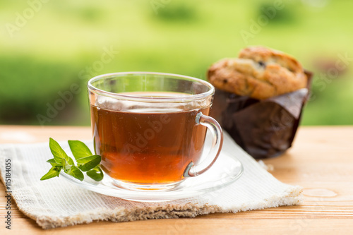 Herbal tea in a cup with and honey, summer garden
