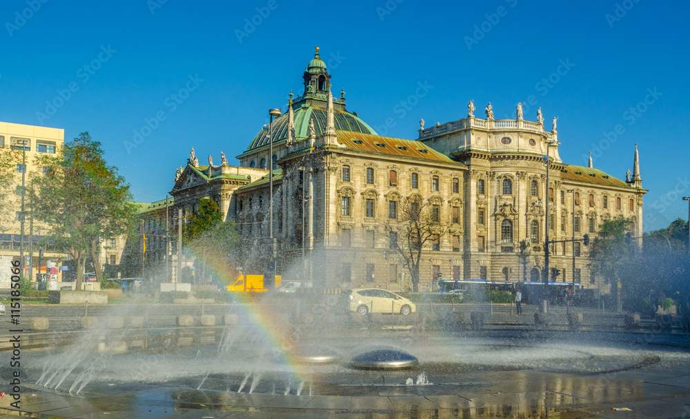 Fototapeta premium View of langericht court in german city munich hidden behind magnificent fountain.