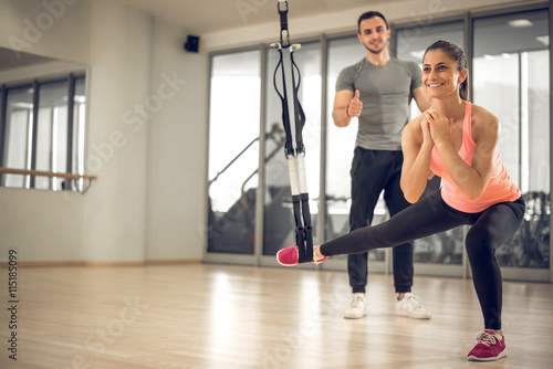 Suspension exercise with personal trainer.
