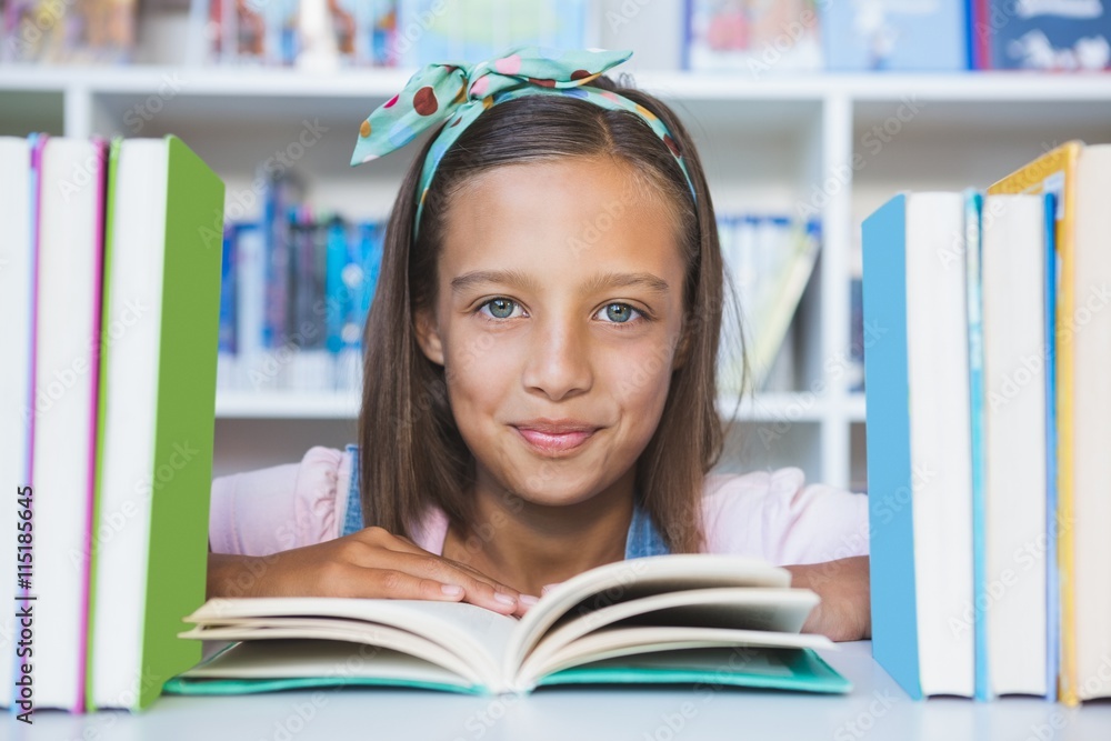 School girl reading a book in library School girl reading a book in library