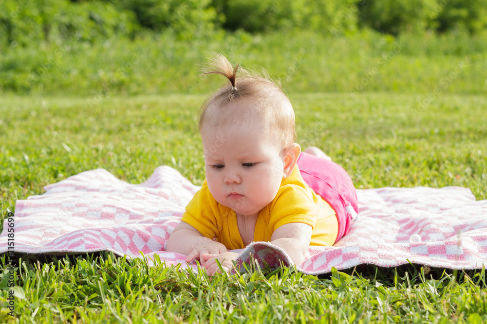Little newborn girl lying on the grass Little newborn girl lying on the grass