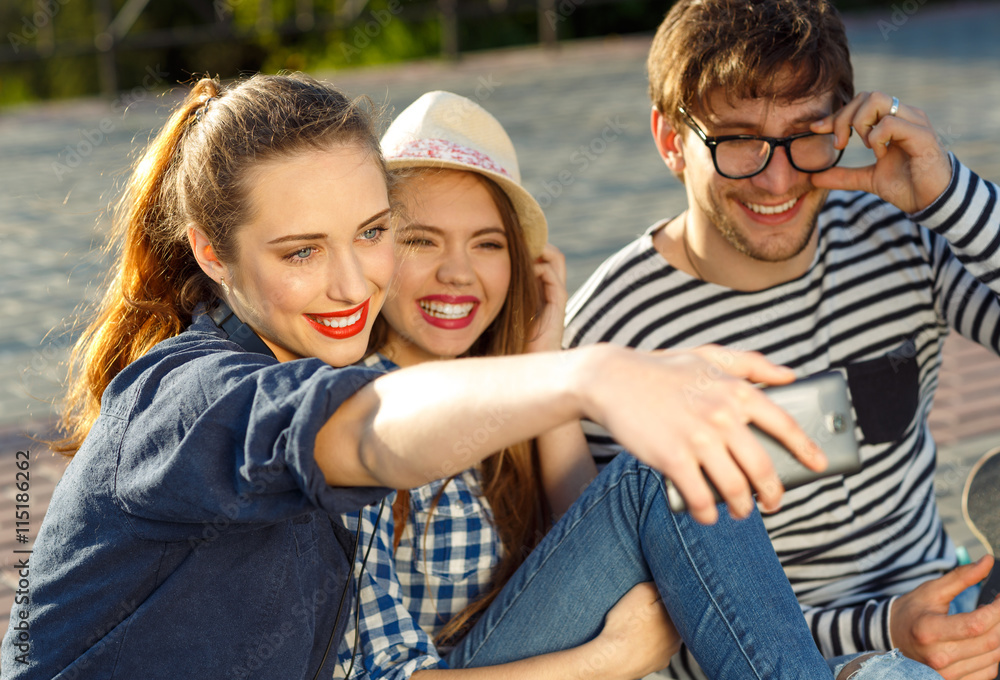Smiling friends making selfie outdoors Smiling friends making selfie outdoors