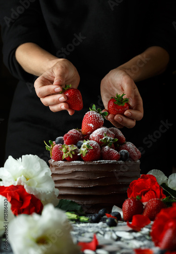 Rpe strawberries in a chocolate cake on a black photo