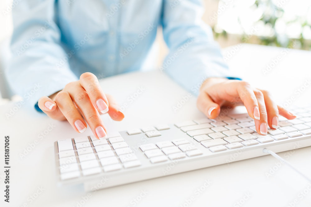 Woman office worker typing on the keyboard Woman office worker typing on the keyboard