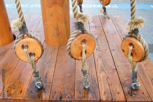 Wooden Pulleys With Rope Around a Post
