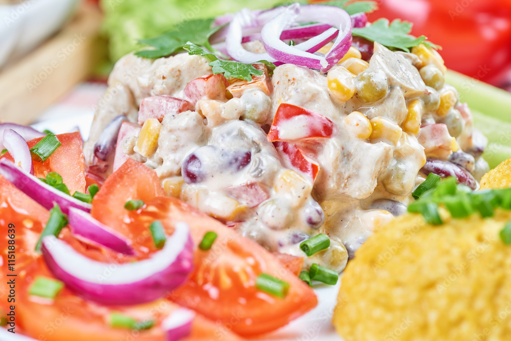 Chicken and vegetable salad on a white plate. Salad ingredients Chicken and vegetable salad on a white plate. Salad ingredients