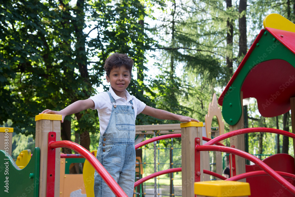 afro american school boy plays on playground