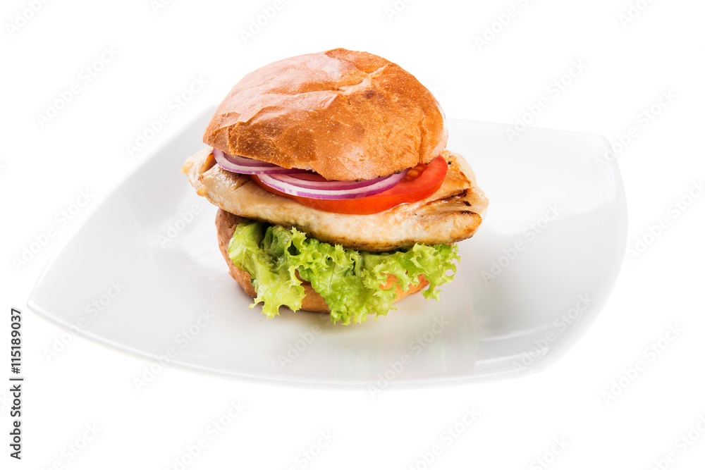 Delicious chicken burger with lettuce and tomato isolated on white background Delicious chicken burger with lettuce and tomato isolated on white background