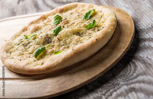 Pizza quattro fromaggi on rustic wooden background