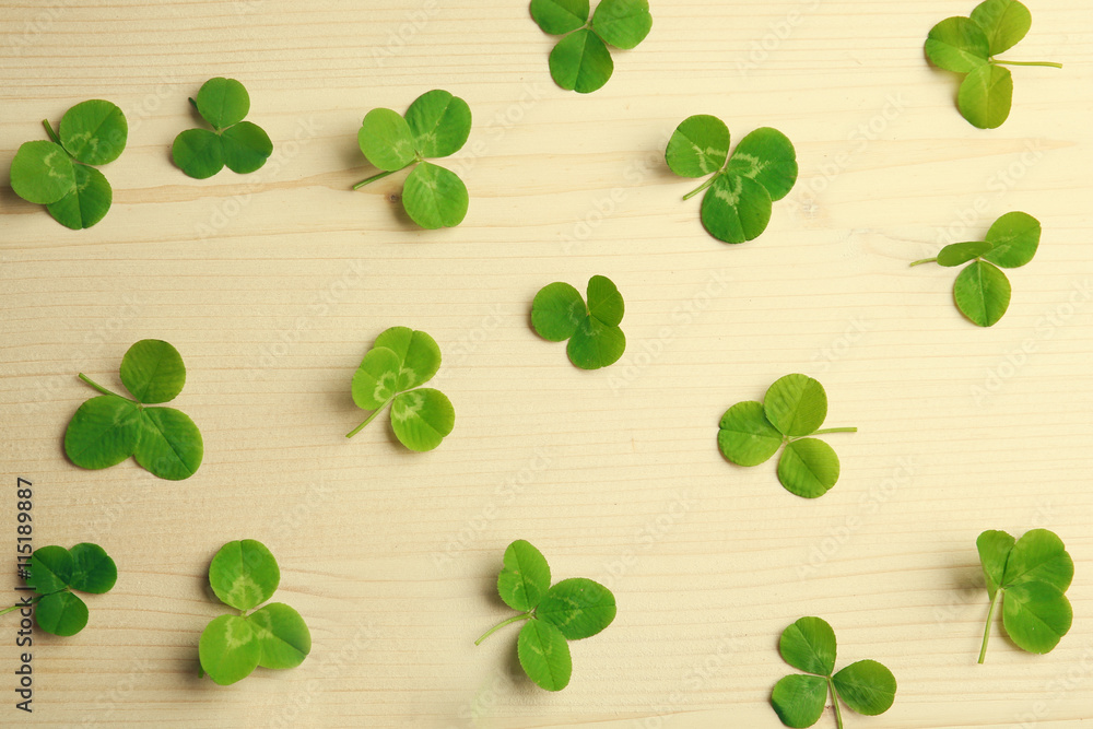 Clover leaves on wooden background Clover leaves on wooden background