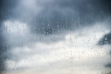 rain drops on glass with dark cloud on back