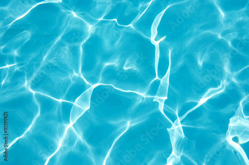 Ripple water surface with sun reflection in swimming pool