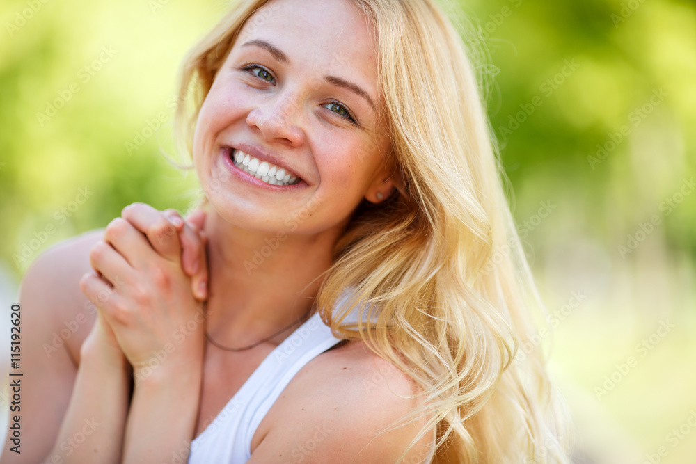 Cheerful woman with green eyes, bright smile and looking at camera