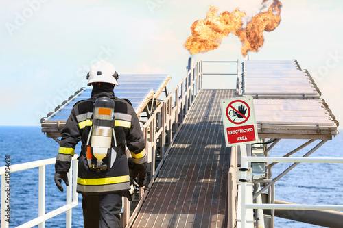 Fire fighter on oil and gas industry, successful firefighter at work , Fire suit for fighter with fire and suit for protect fire fighter, Security team when fire case. restricted area or danger area.