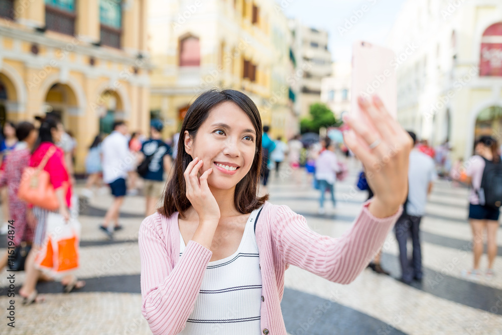 Woman taking selfie in Senado Square of Macao