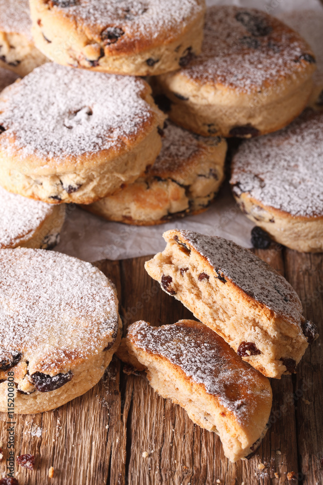 Traditional Welsh cakes with raisins and powdered sugar macro. vertical

