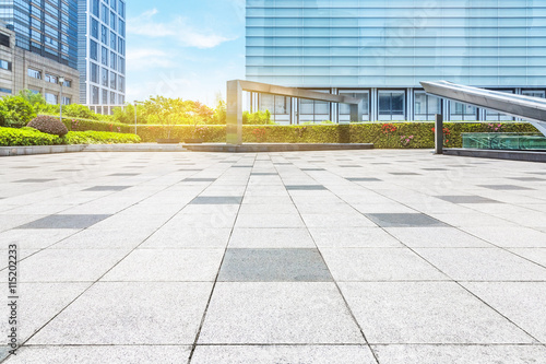 empty pavement and modern buildings in city © kalafoto