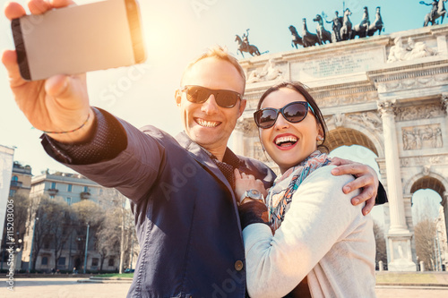 Fotografie Happy couple take a selfie photo on the Arch of Peace in Milan