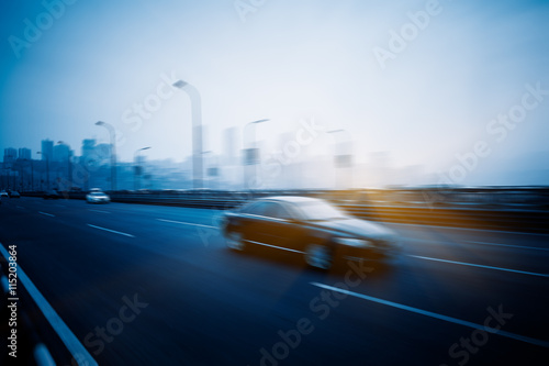 motion blurred traffic with city skyline background