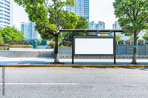 clean road with bus stop and modern buildings background