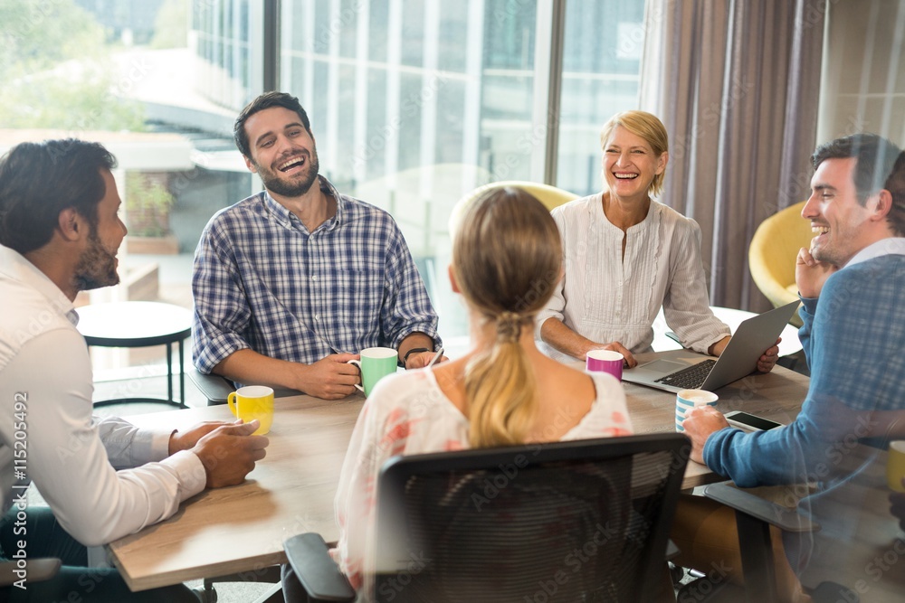 Business people holding coffee mug during a meeting Business people holding coffee mug during a meeting