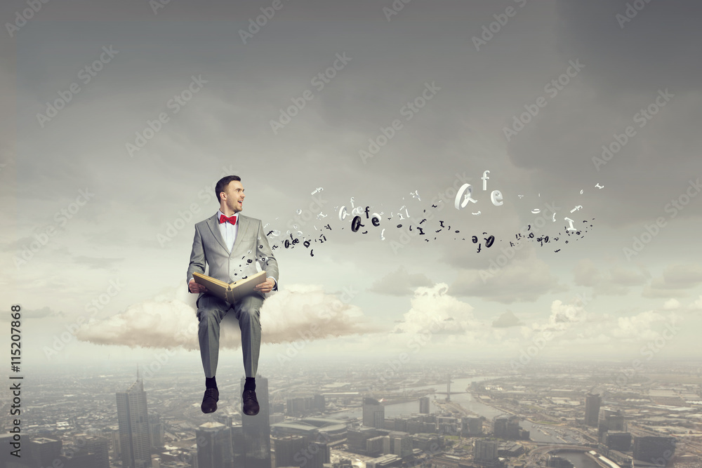 Businessman reading old book . Mixed media