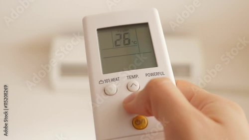Air conditioner remote use for setting lower temperature and cooling down the room 4K 2160p UHD footage - Air conditioning room temperature by remote control 4K 3840X2160 UHD video 