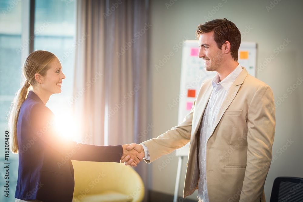 Businessman shaking hands with businesswoman Businessman shaking hands with businesswoman