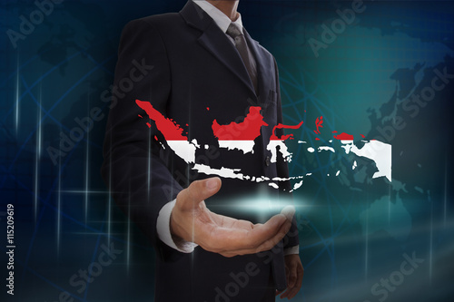 Businessman showing map of Indonesia on globe background
