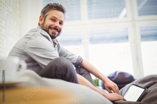 Young businessman working digital tablet in creative office