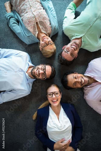 Business team lying on the floor with head together