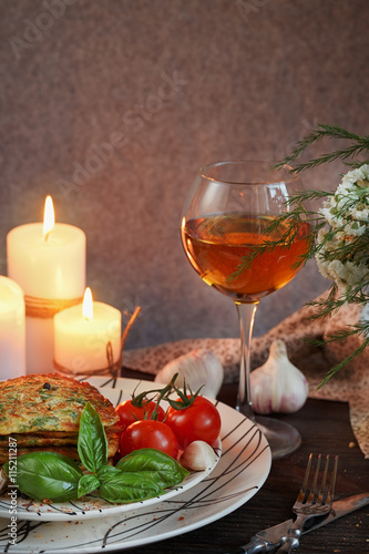 Vegetarian zucchini fritters served with fresh herbs, tomatoes a