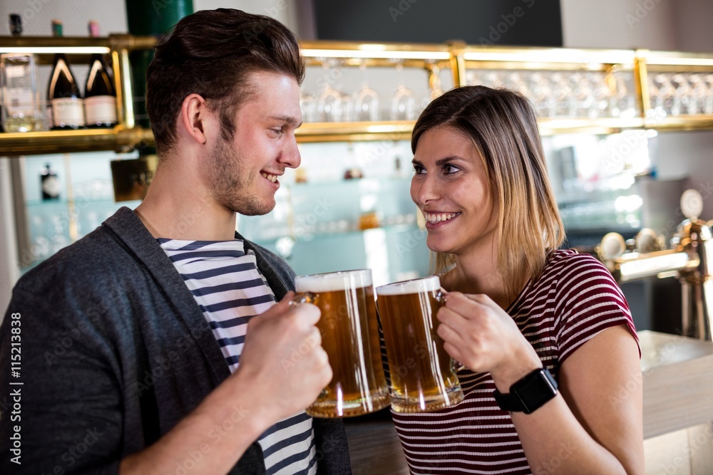 Happy young couple toasting beer mug Happy young couple toasting beer mug