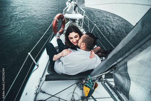 Pretty couple outdoor relaxing on the yacht