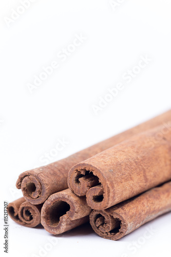 Cinnamon sticks over white with copy space