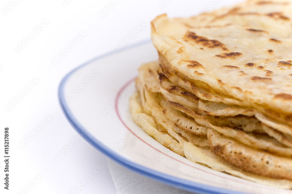 Homemade pancakes on the plate. Isolated on white background. Homemade pancakes on the plate. Isolated on white background.