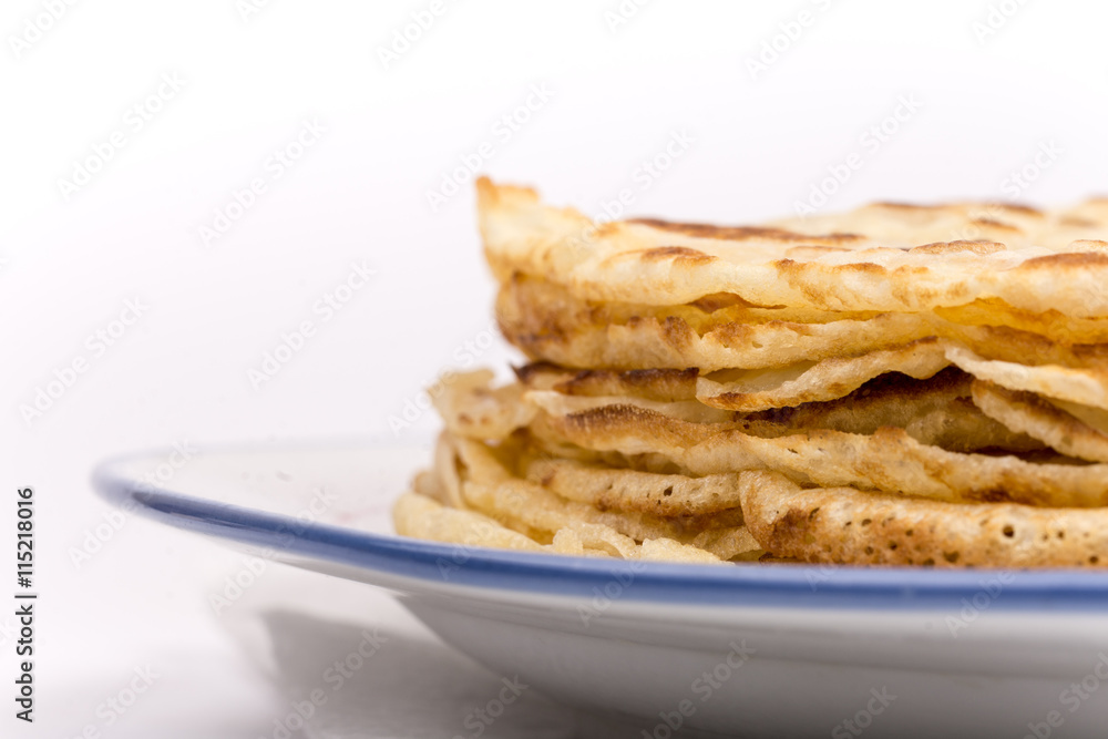 Homemade pancakes on the plate. Isolated on white background.