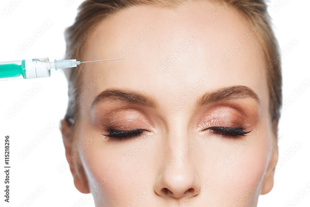 woman face and syringe making injection