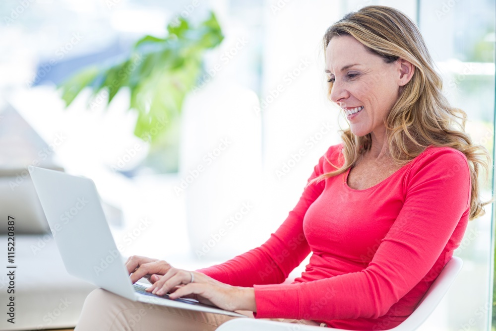 Woman smiling while using laptop Woman smiling while using laptop