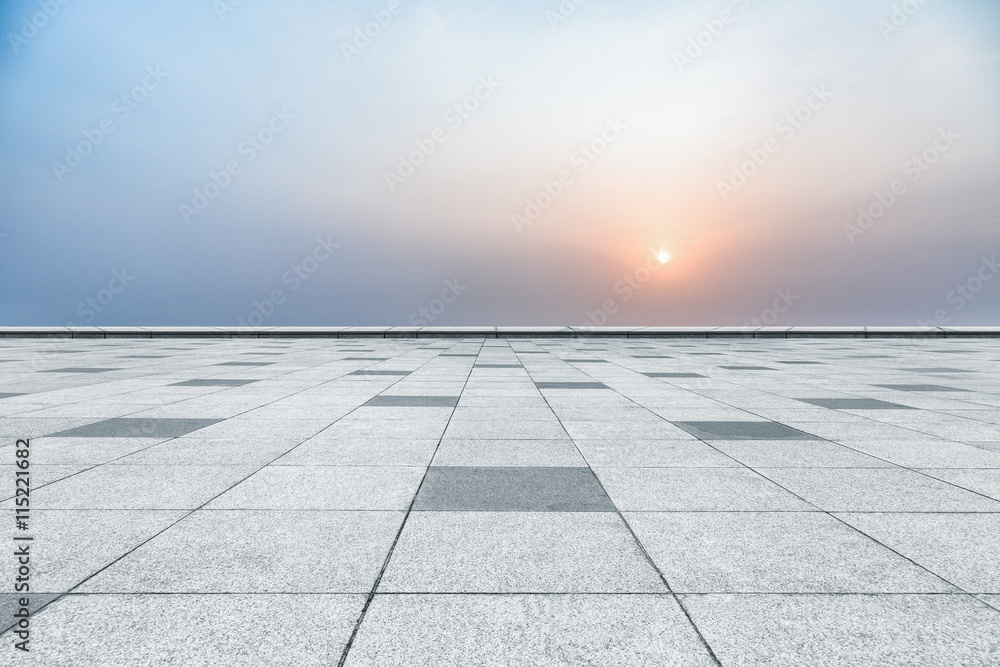 Fototapeta premium empty tiled floor against sunset
